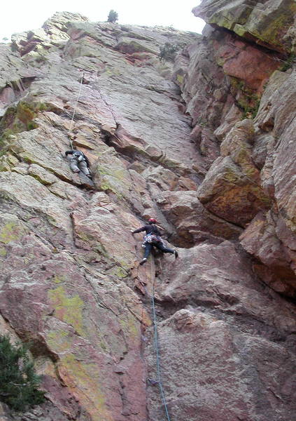 Christa Cline leading the first pitch; the crux roof looms above.  Climber to the left is on Rewritten.