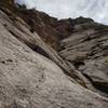 Looking up from my P3 belay. Here is the unprotected, but more direct line that Camino Real might take. We opted to down lead a crack to the right which got us back into the dihedral on Red Sling.