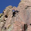 Christa Cline cranking the layback into the V-slot near the top of the pitch.