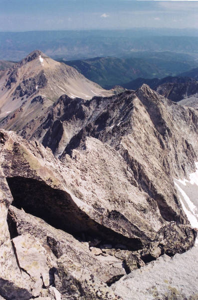 The entire route from near the summit, July 2003. K2 is the peak to the right, Daly is behind to the left. You can make out the knife edge just in front of K2, as well as the overhanging cliff that forces you to drop north from K2.