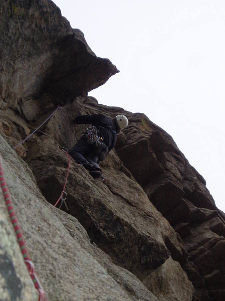 On the 3rd and last pitch. This pitch is 8 or easy 9. It's way runout above the ceiling at the skyline above Chuck with the difficulty depending on how directly you climb. Maybe 5.6 or 7 if you climb straight up. Fun on TR.<br>
<br>
The old bolt is in the groove at the bottom left of the photo. Chuck chose to climb the natural line directly above the belay and right of the bolt, but should you choose to climb directly at the bolt, there is some gear, and the moves at the bolt are not particularly hard.