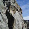 The crux is where the left wall bulges out to almost meet the right arete. The 2-bolt anchor is in the shadowed area at the top left of the photo.