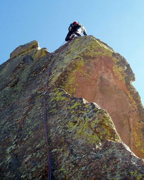 Above the third bolt. It's a long way to the 4th bolt, but the climbing is easy. You can get some mediocre gear above where Luke is.