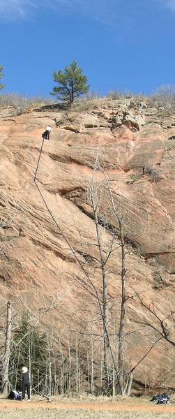 Climber at the top of Pikes Peak, rope line marked with a black line.