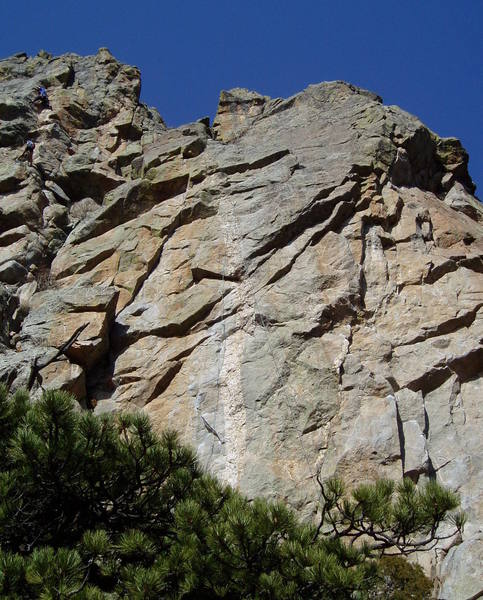 The route climbs just left of, and occasionally on, the white dike. The climbers in the top left of the photo are on the last pitch of Cracking the Code.