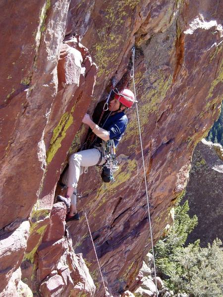 Wedging your shoulder into the wide crack enables you to place gear high and let go with both hands.