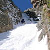 Brian climbing toward the first mixed step about 300' up into the couloir proper.  Normally this is a rocky step, but this weekend it was covered almost entirely in snow with a little rotten ice and rock in evidence.  He soon regretted the fact that I still hd the rope in my pack.  June 5, 2005.