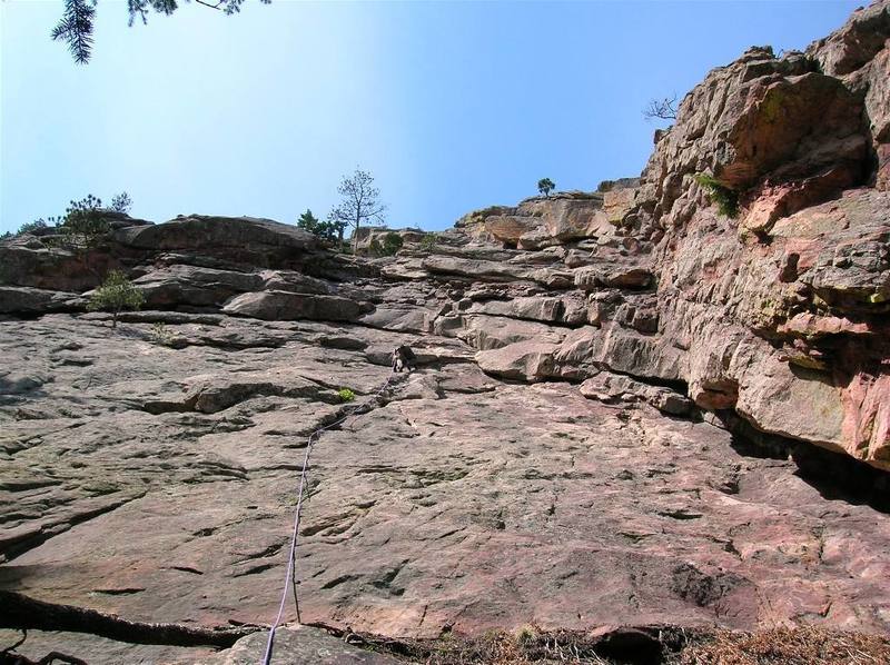 Climbing the slab to the first belay on P1.