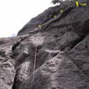 A Brief History of Time.  Climb the big flake, place a couple of pieces of pro, and step left onto a slab.  Work up and right past three bolts, then fire the flared finger and hand crack (crux). More slab climbing leads to the anchor.