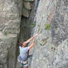 Climber on the sustained crux section of Dead Again.