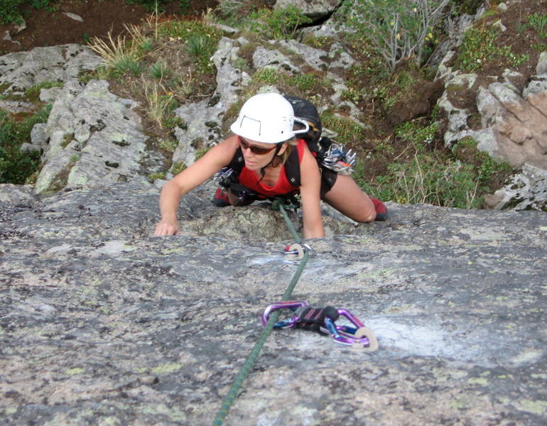 Nickie Kelly at the horizontal crack on the steep upper face.  The hardest moves are above her at the last two bolts.