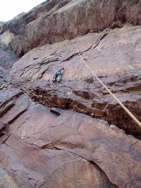 Tony trying the 12a direct variation. You can see tthe left facing, right leaning corner directly below Tony below the roof and ledge.