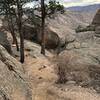 The walkoff is to the south and west-ish of Acid Rock. After you summit Acid Rock, trend south and west-ish looking for a tree with the walkoff signs. This is the first one you'll find, they are diamond-shaped, and most have faded arrows on them.