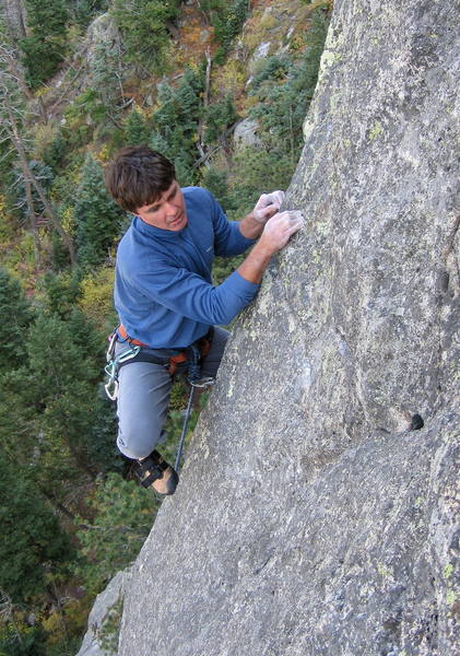 Woody stepping onto the slab at the upper crux.