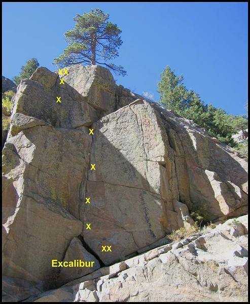 Second pitch of Excalibur. Climb a steep corner and step left to a ledge. Stem a short corner to a sloping ledge (crux) and continue to the anchor.<br>
<br>
The direct start climbs the steep wall directly below the second pitch. The easy start comes in from the right. 