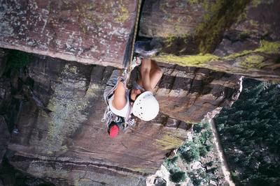 Joseffa cleaning pro and about to turn the lip of the roof on Vertigo. (5.11b, Eldorado Canyon) Photo by T. Bubb, Autumn 2005.
