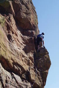 At the fix pin, peering around the corner. It's very exposed here, but the move around the corner is easy.