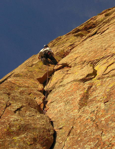 Mike leading the beautiful curving corner on our third pitch.  Mike will continue up to the roof and turn it on the left. <br>
<br>
Above, he will climb straight up to an airy ramp, follow it left and up, then continue straight up past a prominent chicken head to the top.