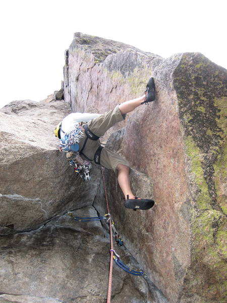 Brenda starting the crux sequence.  Her right foot is on the only good foothold.<br>
She has to get her left foot over the lip of the roof, even with the current position of her left hip.