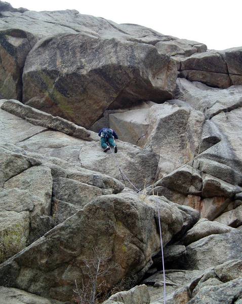 Ran is traversing into the corner. From below, this bit looks like it will be hard and scary, but there's gear, and the holds are big. You can also climb over the roof directly into the overhang (I think I've done it that way).