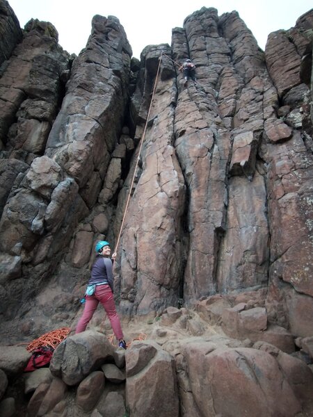 The climb follows the rope line before moving right around the block near the top. The easier start is left of the rope.