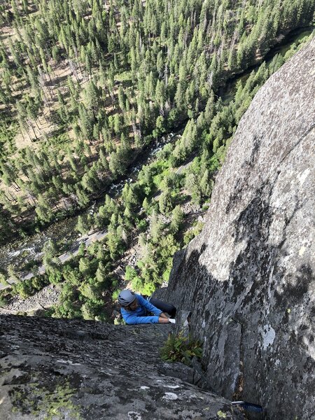 Getting ready to top out pulling through the crux.