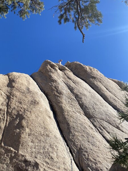 Once above the crack, mantle the boulder to the right and walk to the chains.