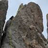 Hitching Post with climber on the rappel. You can show boat rap down the opposite face into the parking lot, or rap the same side as you ascended, which is more descrete.