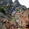 Looking up at the descent route (Mile High Club rap route) and scramble.