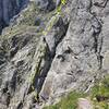 First pitch of la voie Frison-Roche, seen from the end of the approach trail. Climber is near the crux of the first pitch.