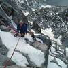 Mary Erdei at a belay on our attempt on a new line above the South Gully on the W Face of Helen in Sept 1980. Pretty stormy conditions that year as you can see.