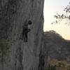 Arief hitting the crux move using short climber beta.