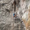 Caymon finishing the 11 crux on P2 of Midsummer. Photo taken by self, 10/7/2021.