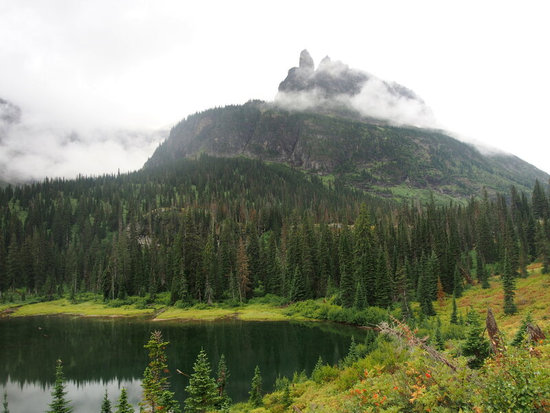 Rising Bull Ridge (and pinnacles) as viewed from the Upper 2-Med Lake Trail at the small pond about a quarter mile below Upper 2-Med Lake (whose flat area you can see just below the lower tree tops)