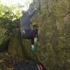 Heidi working her way up on New Endeavors V0 on Giddy Up boulder