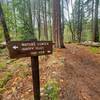 Trail sign to the Grack. Follow this sign to the small A-frame and take the small trail up towards the wall (water left of the trail)