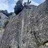 Fun variation on the big ledge to the left. Get up into the slabby dihedral w/ finger crack, then transition to the hand crack(s) to the right, 5.8/9. Easy to get back to the OG route at the top.