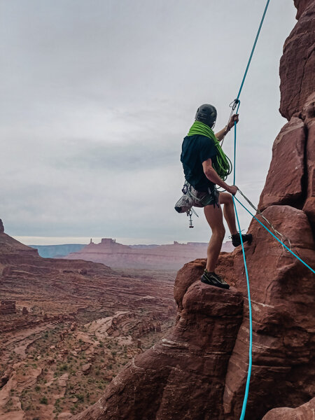 Rappelling off the catwalk back to the party ledge. Castleton Tower in the distance.