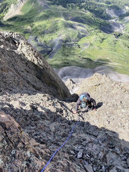 Coming up P3 just below the summit. The original route finishes 30ft to climber's right where the chains, are but this is much better.