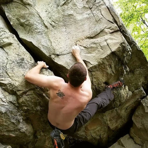 Climbing the outside of the offwidth on the Bubba Boulder