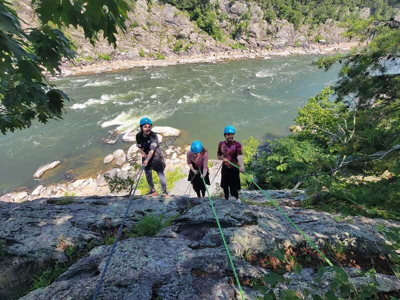 Clients with Northeast Mountain Guiding rappelling on the cliffs