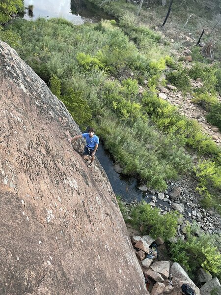 Tyler Smith enjoying the big rest ledge early on the route before getting back into it