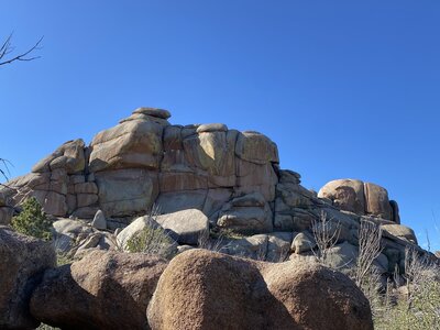 Poland Hill seen from a SSE aspect with a climber on Skull, and Fantasia is seen farther back and right splitting the small dome. Kim is partially visible to the left of Fantasia.