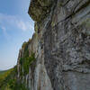 Approaching the belay at the end of pitch 2 on a beautiful day with a bird soaring behind.