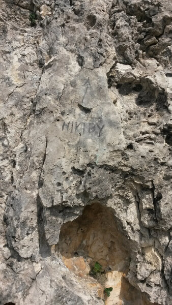The route description says "Start about 3 meters (10 feet) right of where the route name is scratched into the rock." You'll know you've found it when you see this. Photo taken in August 2015.
