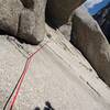 Pro on traverse (E->W): #6 WC Offset nut set in small left facing crack, single sling on rock spur, ULMC #3 & WC 0.5.