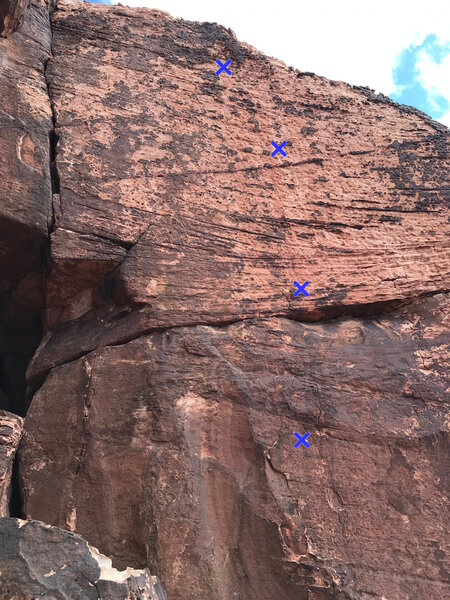 The four bolts of Country Bumkin are marked in blue. The route on the left is City Slickers. Both routes have bolted anchors, but they don't seem to be visible from this angle.