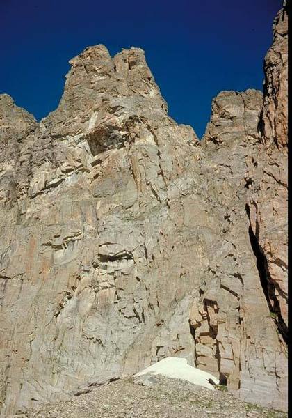 East face of Ptarmigan Tower 4.  The NE Corner route (5.9) follows the right-hand of two prominent dihedrals, leading past the R side of the central overhangs.