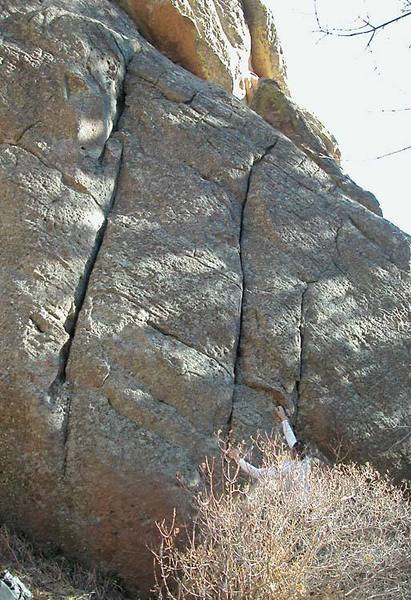 "Pictureman Crack" on the Left, Warren (behind bush) has just bouldered the crux of the right crack "In Focus"