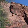 Pitch 4, which leads to the main upper dihedral system.  Route traverses into crack from the left, Greg is following and nearly at the belay.